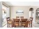 Formal dining room featuring neutral walls, a sliding glass door, and a wooden table with seating for six at 2734 Ashland Ln, North Port, FL 34286