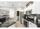 Open-concept kitchen featuring granite countertops, stainless steel appliances, and seamless access to the dining area at 2734 Ashland Ln, North Port, FL 34286