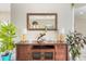 Bright living space showcasing a wooden console table, decorative plants, and an ornate mirror at 2734 Ashland Ln, North Port, FL 34286