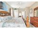 This cozy main bedroom features a beautiful ceiling fan, matching dresser, and beach-themed decor at 2734 Ashland Ln, North Port, FL 34286