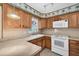 Kitchen featuring wooden cabinetry, formica countertops and standard appliances at 2817 Miriam S St, Gulfport, FL 33711