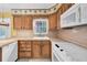 Kitchen featuring wooden cabinetry, formica countertops and standard appliances at 2817 Miriam S St, Gulfport, FL 33711