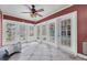 Enclosed sunroom features tiled flooring, ceiling fan and multiple glass panel doors at 2817 Miriam S St, Gulfport, FL 33711