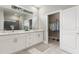 Bright bathroom featuring a double vanity, neutral color palette and walk-in closet at 3083 Sikeston Ave, North Port, FL 34286