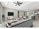 Bright living room featuring contemporary furnishings, neutral tones, and an open layout connecting to the kitchen and dining area at 3083 Sikeston Ave, North Port, FL 34286