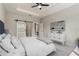 Spacious main bedroom featuring tray ceiling, sliding barn door to the bathroom, and chic decor at 3083 Sikeston Ave, North Port, FL 34286