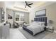 Elegant main bedroom showcasing tray ceiling, large window, and calming color scheme at 3083 Sikeston Ave, North Port, FL 34286