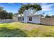 This backyard features a pool, a screened-in lanai, a wooden privacy fence, and a grassy area at 3084 Williamsburg St, Sarasota, FL 34231