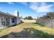 Large backyard featuring both a screen lanai and tall fence providing privacy at 3084 Williamsburg St, Sarasota, FL 34231