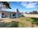 Spacious backyard featuring a screened-in porch and a lush green lawn, perfect for outdoor activities at 3084 Williamsburg St, Sarasota, FL 34231