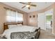 Bright bedroom with neutral walls, ceiling fan, and natural light from two windows at 3084 Williamsburg St, Sarasota, FL 34231