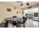 Charming dining area leading to a sunlit game room with a pool table and fireplace at 3084 Williamsburg St, Sarasota, FL 34231