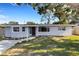 Charming single-story home with a well-maintained lawn and a welcoming front entrance, creating a cozy curb appeal at 3084 Williamsburg St, Sarasota, FL 34231