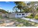 Charming single-story home features a well-maintained lawn and inviting walkway at 3084 Williamsburg St, Sarasota, FL 34231