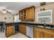 Kitchen featuring wooden cabinets, black countertops and a wine fridge at 3084 Williamsburg St, Sarasota, FL 34231