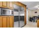 Kitchen with stainless steel refrigerator and microwave, complemented by wood cabinets at 3084 Williamsburg St, Sarasota, FL 34231