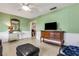 Inviting living room featuring light green walls, ceiling fan and stylish furnishings at 3084 Williamsburg St, Sarasota, FL 34231