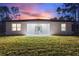 A spacious backyard featuring a concrete patio accessed by sliding glass doors at 4044 Simkins Ave, North Port, FL 34286