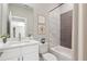 Modern bathroom with a stylish vanity, bathtub with a shower, and elegant finishes at 4044 Simkins Ave, North Port, FL 34286