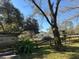 Backyard with mature trees and partially covered structure at 7306 Jones Rd, Odessa, FL 33556