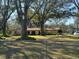 Home exterior featuring a large yard, a chain-link fence surrounding the property at 7306 Jones Rd, Odessa, FL 33556