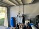 Image of the garage with water filtration equipment, storage boxes, and supplies at 7306 Jones Rd, Odessa, FL 33556