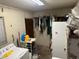 Picture of the storage room showing a washer and dryer, hanging clothing, and a window at 7306 Jones Rd, Odessa, FL 33556