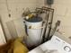 View of the storage room showing a water heater and laundry machine at 7306 Jones Rd, Odessa, FL 33556