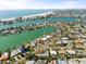 Fantastic aerial view of a home on the water with a pool and picturesque views of the bay at 10111 Yacht Club Dr, Treasure Island, FL 33706