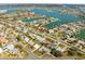 Aerial view of a densely populated waterfront community featuring canal access and a variety of residential properties at 10111 Yacht Club Dr, Treasure Island, FL 33706