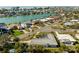 Aerial view of a waterfront home with a swimming pool in a coastal neighborhood setting at 10111 Yacht Club Dr, Treasure Island, FL 33706