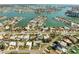 Aerial view of a waterfront community, highlighting residences with docks and scenic waterways at 10111 Yacht Club Dr, Treasure Island, FL 33706