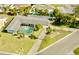 Aerial view of a home's backyard highlighting the screened-in pool and well-maintained landscaping at 10111 Yacht Club Dr, Treasure Island, FL 33706