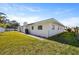 The backyard features a well-maintained lawn, concrete patio, and mature trees at 10111 Yacht Club Dr, Treasure Island, FL 33706