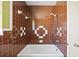 Bathroom features retro brown tile and a classic white bathtub at 10111 Yacht Club Dr, Treasure Island, FL 33706