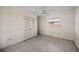 This bedroom has a ceiling fan, closet with white louvered doors, and a window for natural light at 10111 Yacht Club Dr, Treasure Island, FL 33706