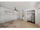 Bedroom featuring a water heater closet, window, an unfinished floor, and tiled ceiling at 10111 Yacht Club Dr, Treasure Island, FL 33706
