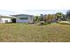 Charming single-story home featuring a spacious yard with mature trees and a cozy screen porch at 10111 Yacht Club Dr, Treasure Island, FL 33706