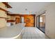 Spacious kitchen with wood paneled walls, white counters, and tile floors at 10111 Yacht Club Dr, Treasure Island, FL 33706