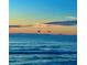 Tranquil ocean view with birds flying over gentle waves, creating a serene scene at 10111 Yacht Club Dr, Treasure Island, FL 33706