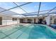 Inviting pool with an enclosed screen, a spacious deck, and easy access to the home's interior at 10111 Yacht Club Dr, Treasure Island, FL 33706