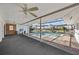 Spacious covered patio with a serene pool and surrounding areas, perfect for entertaining at 10111 Yacht Club Dr, Treasure Island, FL 33706