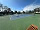 Well-maintained tennis courts with a vibrant blue surface, inviting players for a match at 10111 Yacht Club Dr, Treasure Island, FL 33706