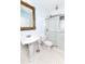 Well-lit white tiled bathroom featuring a pedestal sink, toilet, and glass-enclosed shower at 3530 Oak Ne St, St Petersburg, FL 33704