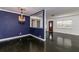 Bright living space with hardwood floors, view into the kitchen, and blue accent wall at 3530 Oak Ne St, St Petersburg, FL 33704