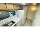 Practical kitchen layout featuring a dual sink, tiled floors, and view into the living area at 7120 Waterside Dr # 106, Tampa, FL 33617