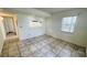 Cozy living area featuring tiled floors, a window, and a passthrough to the kitchen at 7120 Waterside Dr # 106, Tampa, FL 33617