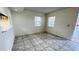 Bright, open-plan living area with tiled flooring, offering plenty of natural light from dual windows at 7120 Waterside Dr # 106, Tampa, FL 33617