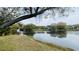 This water view shows calm water with a grassy shoreline and condo buildings across the lake at 7120 Waterside Dr # 106, Tampa, FL 33617