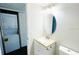 Bathroom with in-unit washer and dryer, updated vanity and stylish lighting at 7113 E Bank Dr # 7113, Tampa, FL 33617